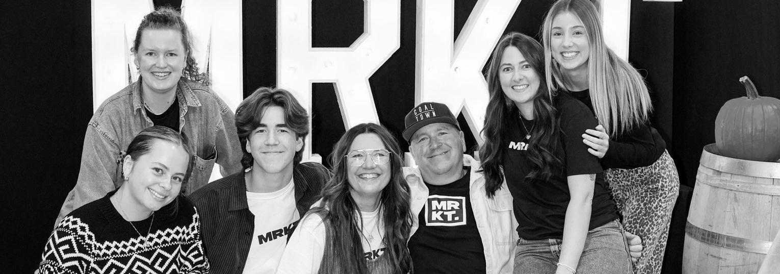 The MRKT team together in front of the MRKT marquee letters